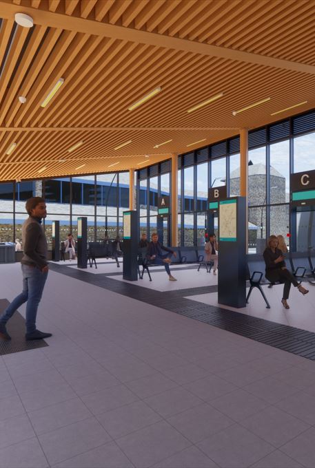 Grey flooring with information screens facing towards the bus station entrance. People in foreground walking through the new bus station