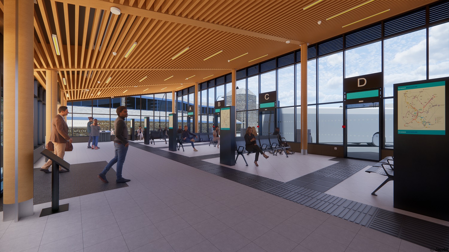 Internal view of bus station with people in the station waiting for buses at the bus stands.