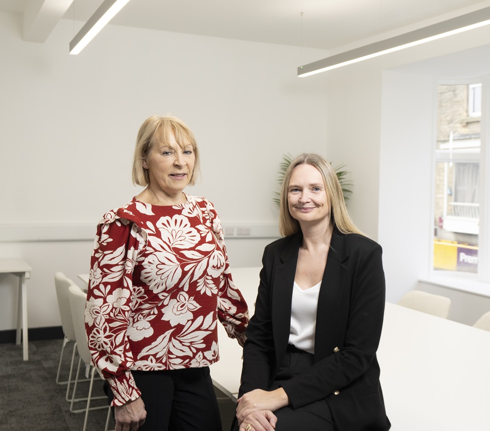 Judith Layfield Vice Principal of Bishop Auckland College (left) with Jennifer Phillips Head of Community and Career at the college standing at the end of a table looking into the camera