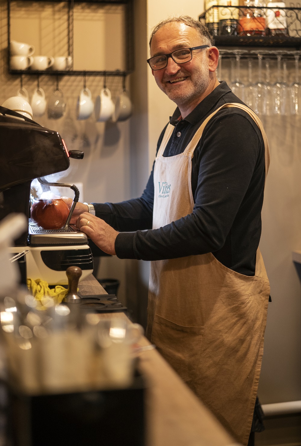 Wayne Parnaby making a coffee at a large coffee machine at The Vines