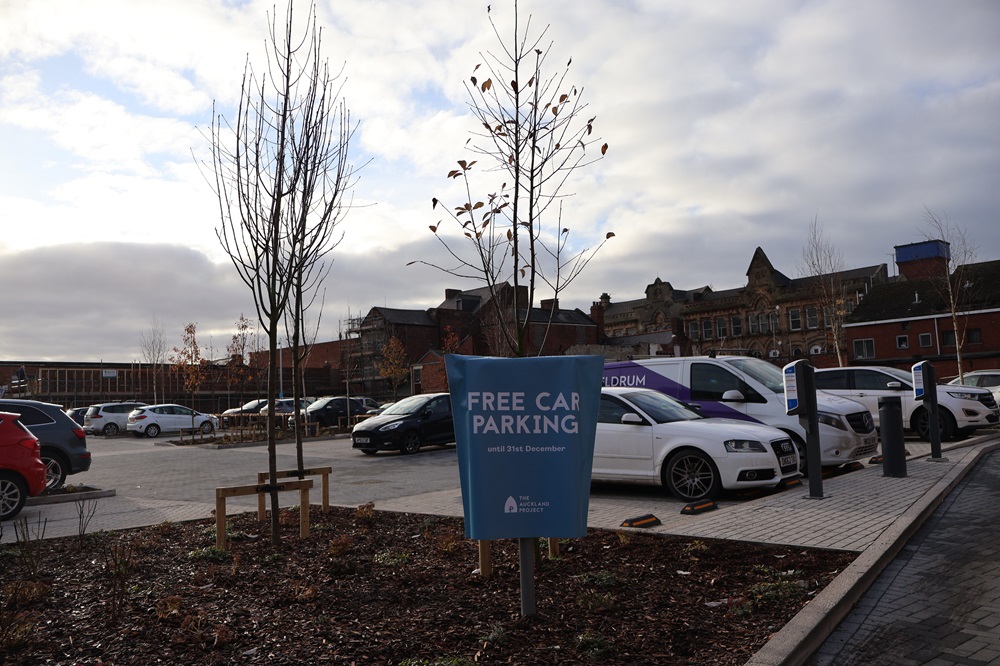 View of Kingsway Car park with cars in background and free parking sign in foreground