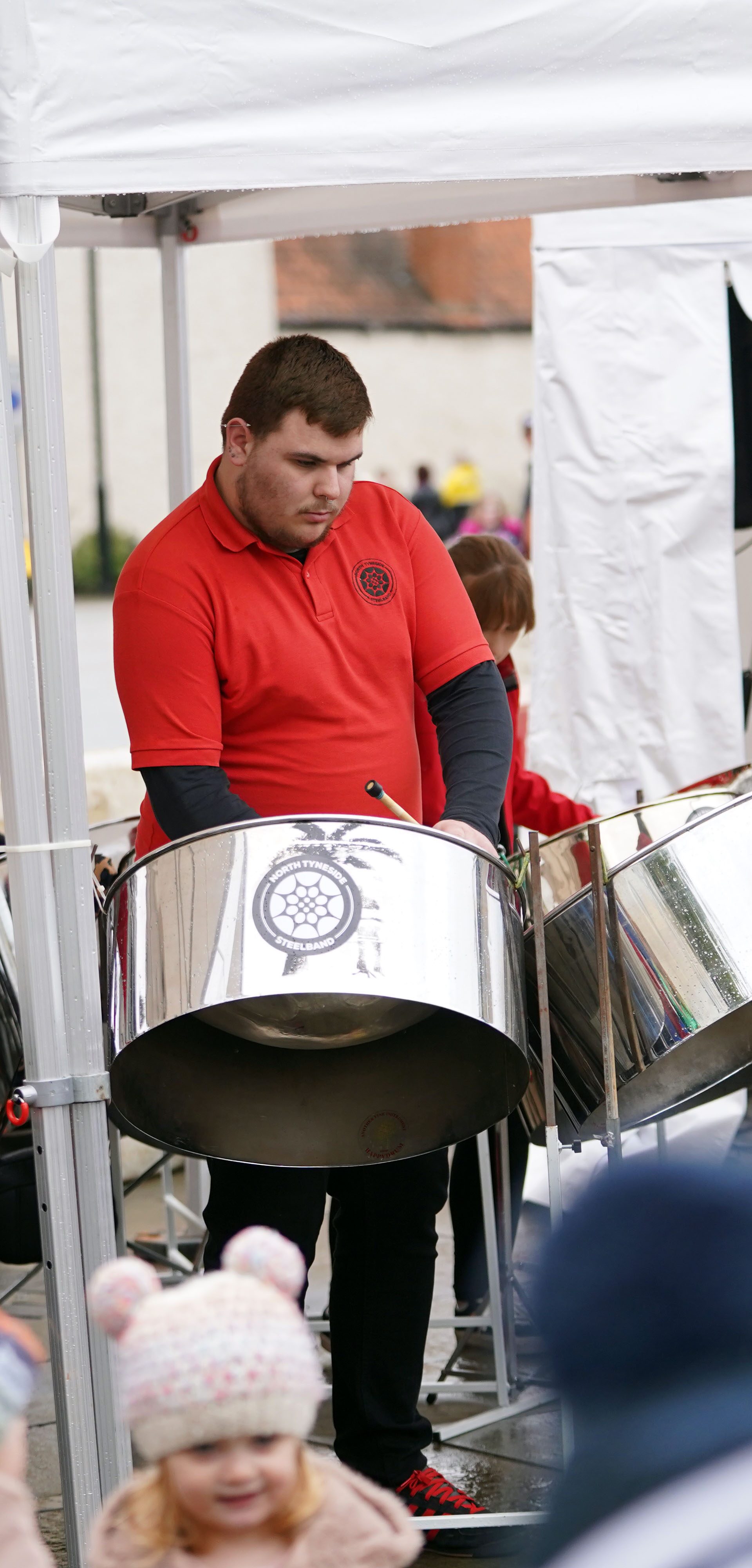 North Tyneside Steel Band performing with steel drums in front of a crowd