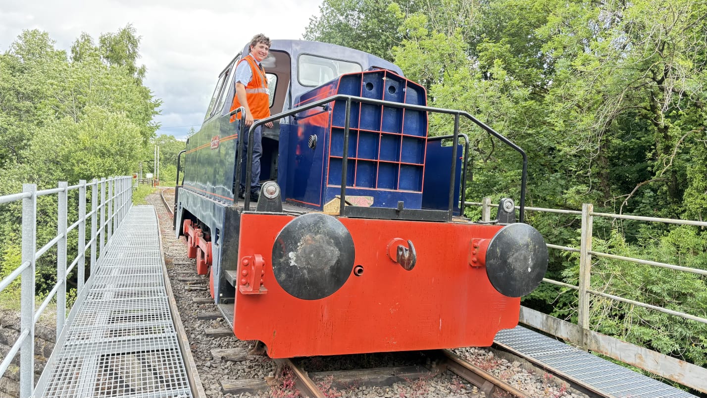 Logane Smallwoord 18 year old standing on the footplate of a diesel engine (train)